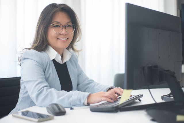 person smiling while working at their desk